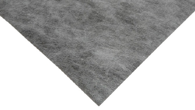 Triangular piece of grey vinyl flooring backing